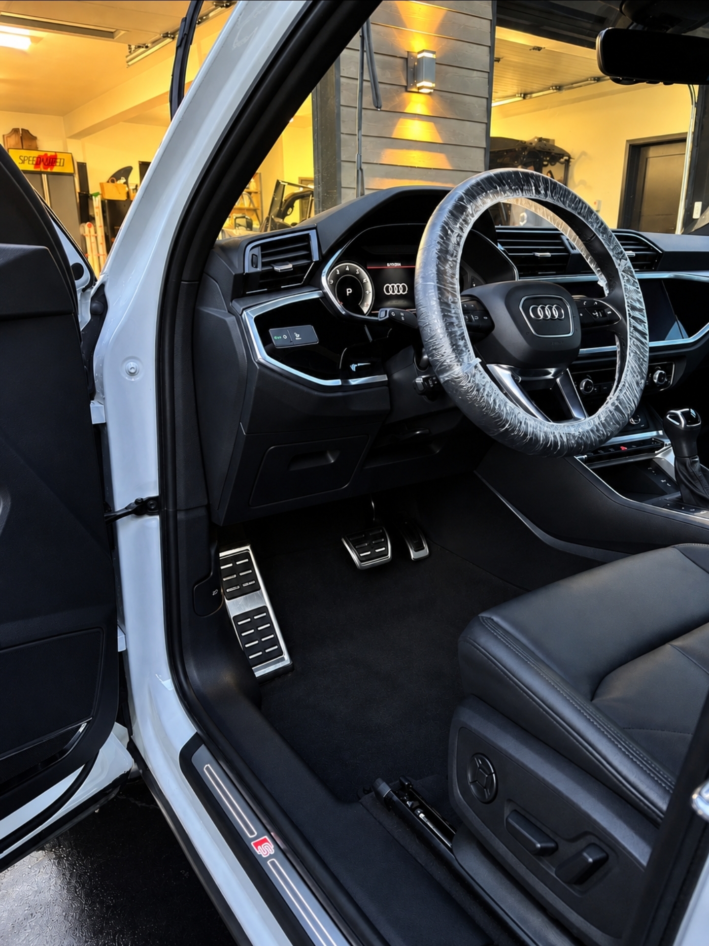 Detailer steam cleaning a luxury SUV interior
